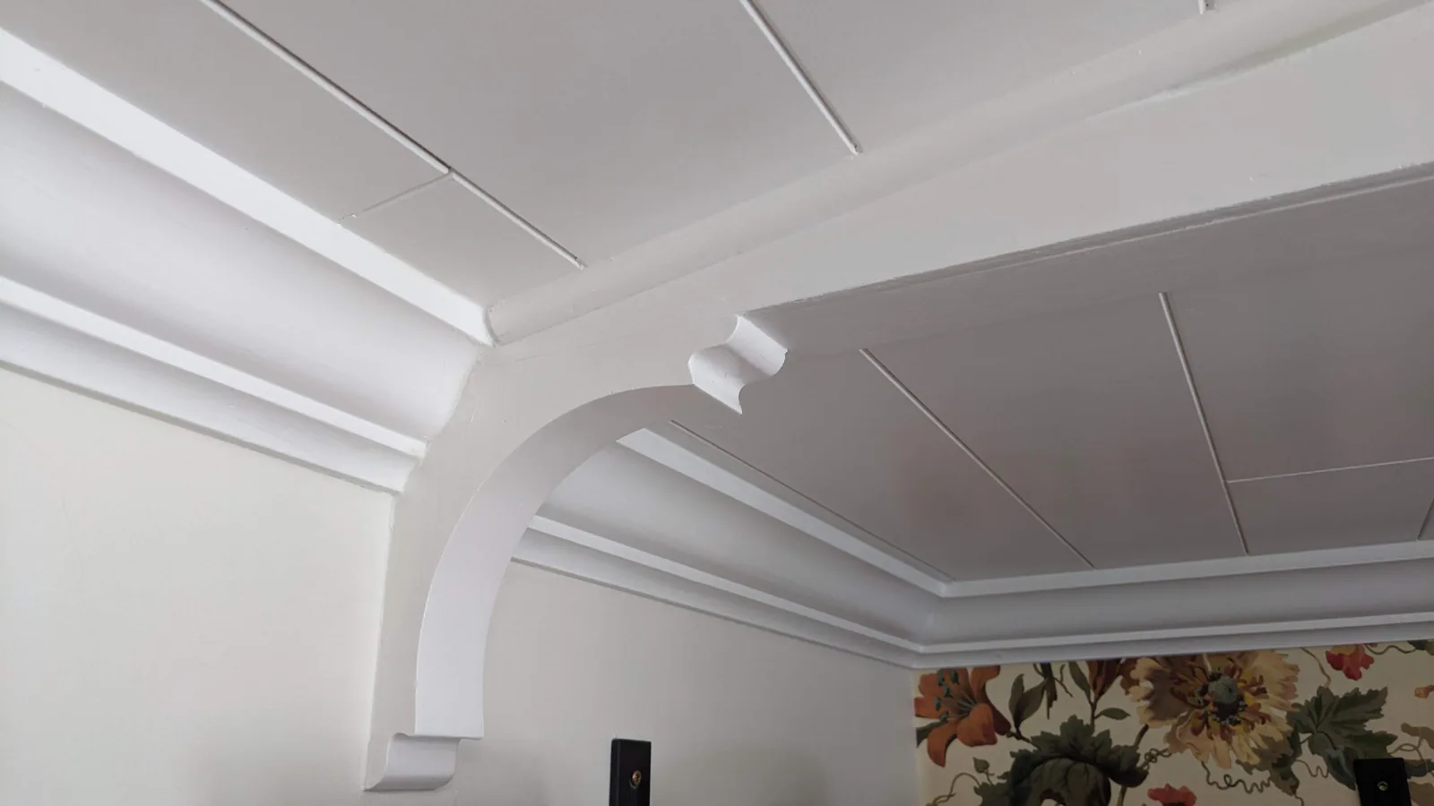 Close-up of tongue-and-groove ceiling planks with clean white finish