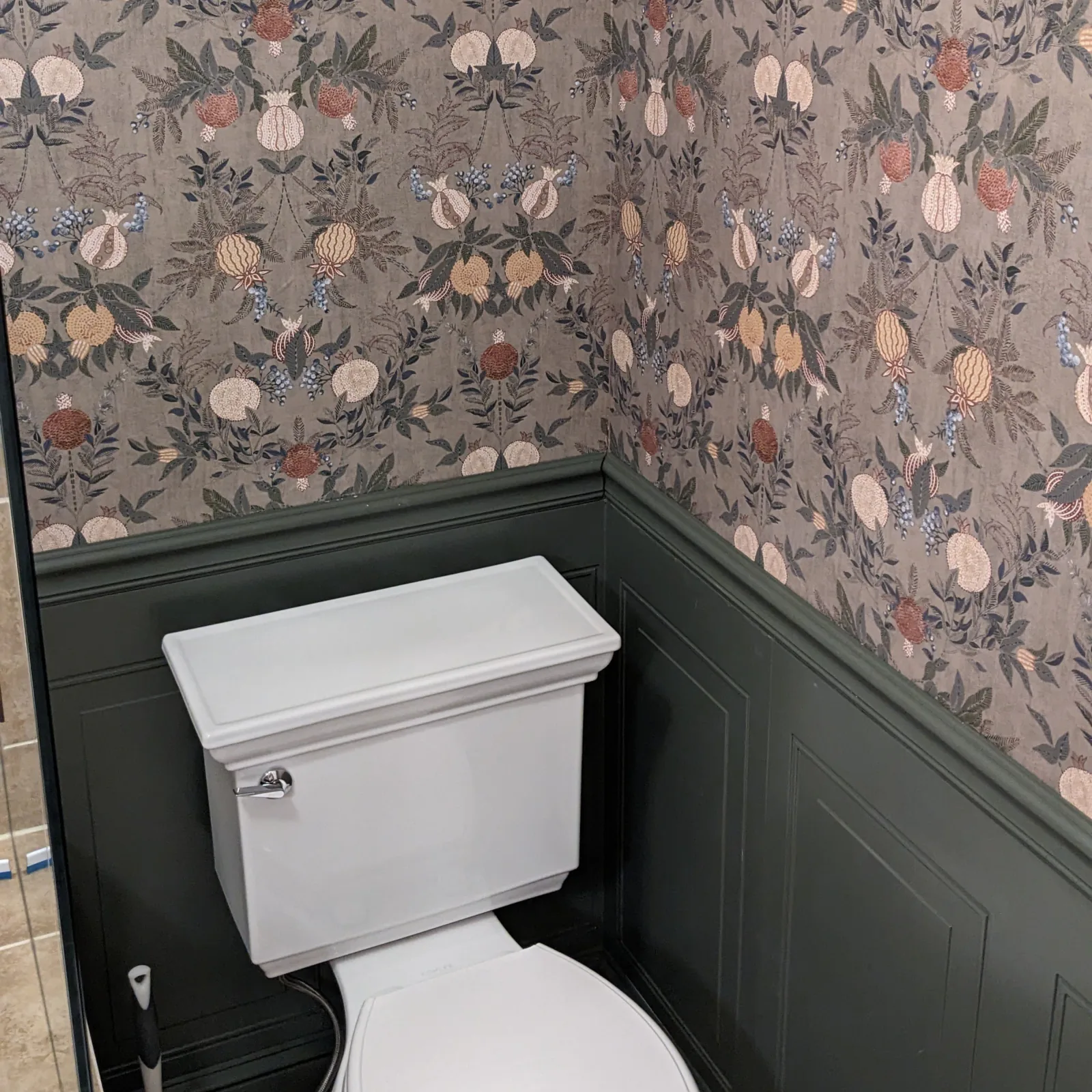 Hex tile floor with border rug, pedestal sink, and beadboard wainscot