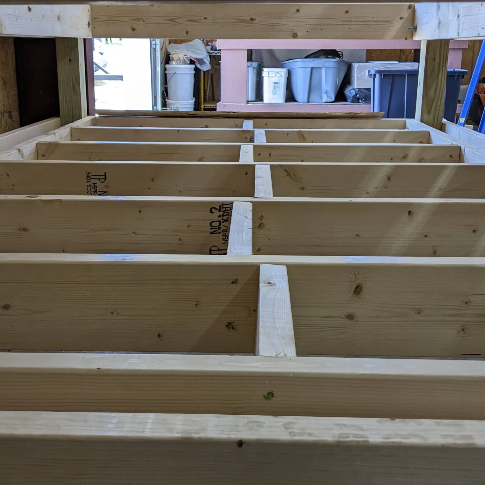 Framed opening with stacked header, jack studs, post, and footing aligned in a clean load path